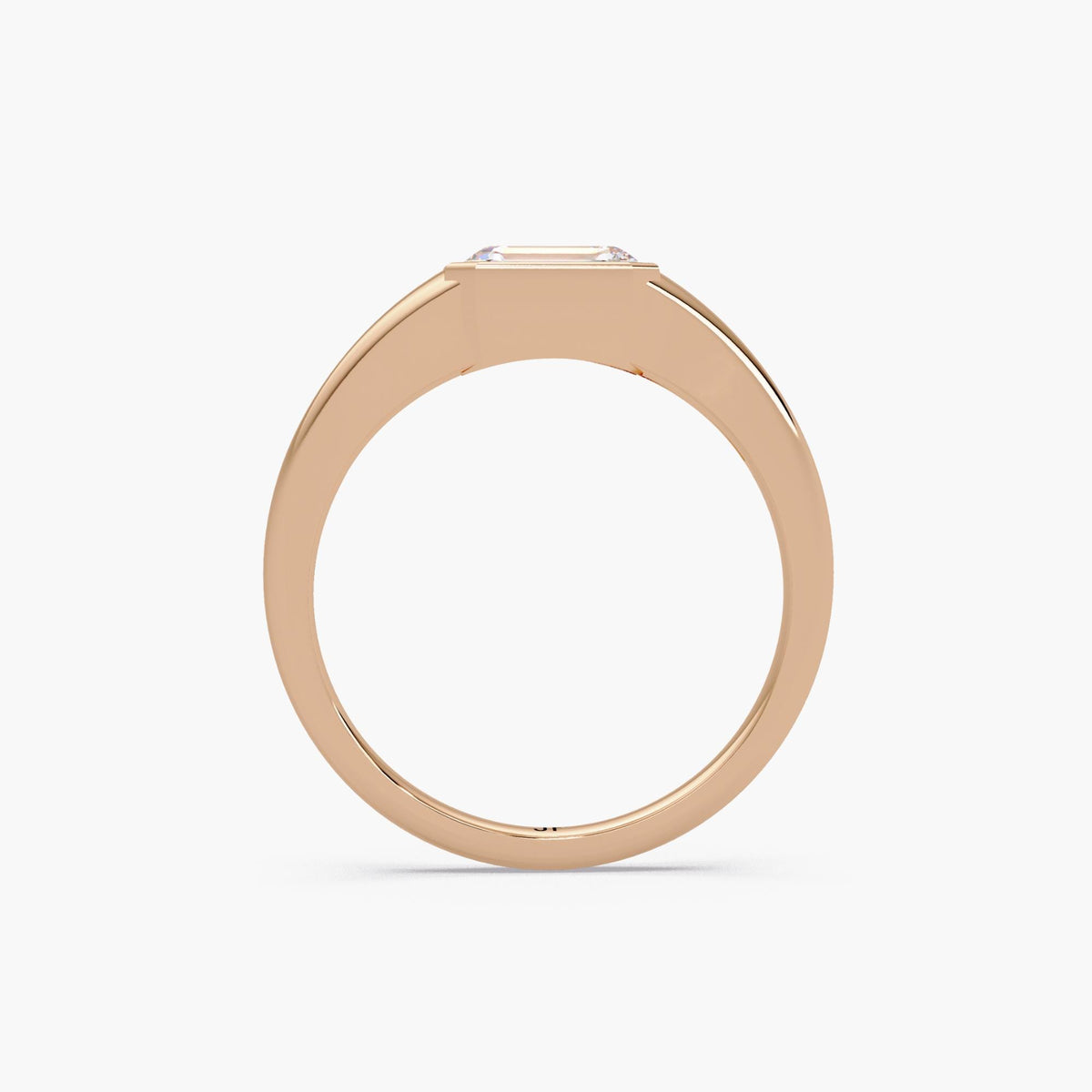 Emerald cut lab diamond signet ring in 14K rose gold with a bezel-set center stone and smooth tapered band, styled as a modern pinky or statement ring for everyday wear.