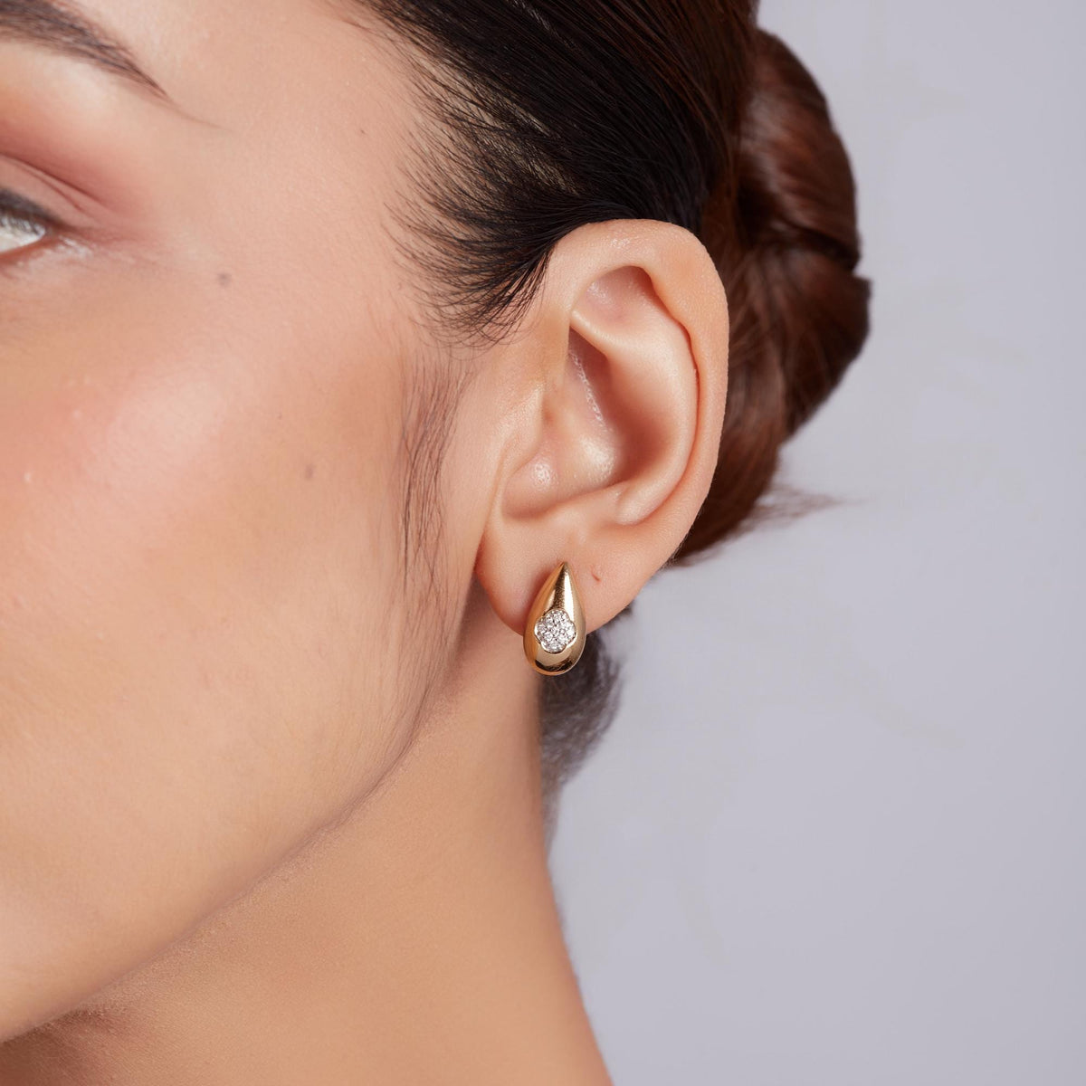 Gold dome stud earrings with pavé diamond detailing, rounded gold stud earrings showcasing natural diamond stud earrings in a bold yet refined everyday statement style