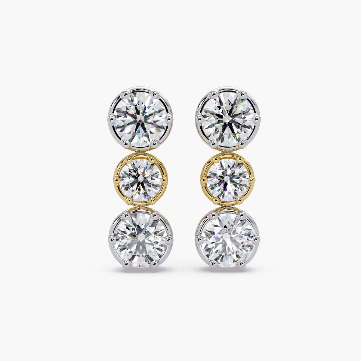 Mixed metal vertical diamond drop stud earrings with alternating white and yellow gold crown settings and three round lab-grown diamonds