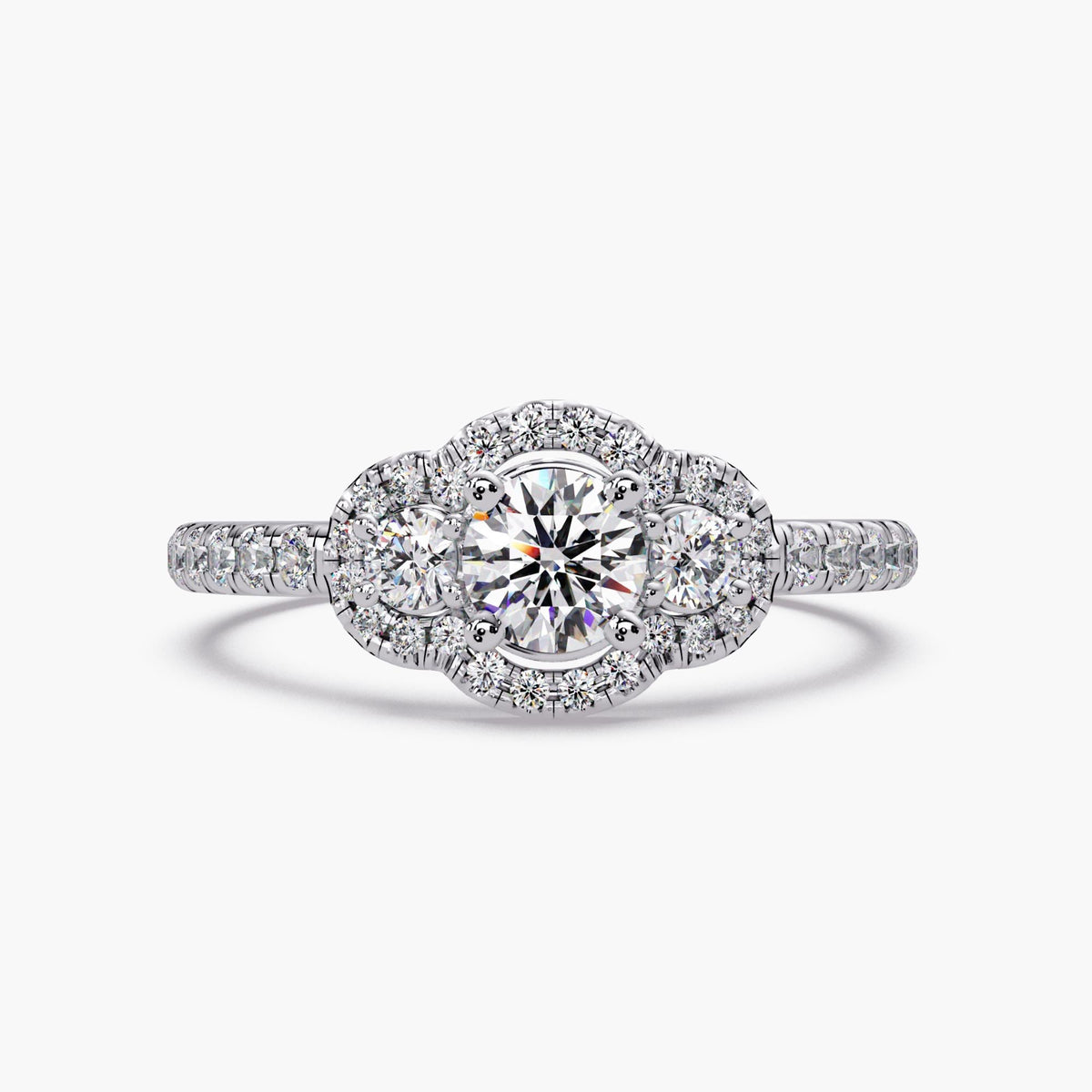 Round lab diamond three stone halo engagement ring in 14K white gold with pavé diamond band and vintage inspired cluster halo design.