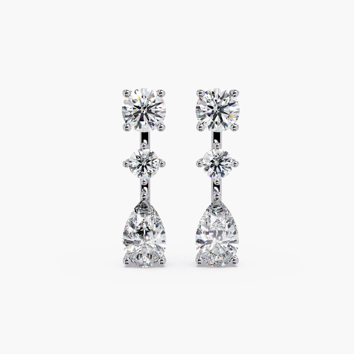 14K white gold lab grown diamond drop earrings featuring round stud top, center round diamond, and pear-shaped diamond drop in prong setting, three-stone vertical design, 2.75 CTW