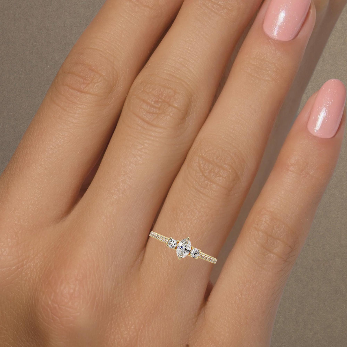 14K gold oval lab-grown diamond ring with three-stone design and pavé band.
A petite, low-profile diamond ring for promise, April birthstone, or meaningful gifting.
Clean, dainty diamond ring made for everyday wear