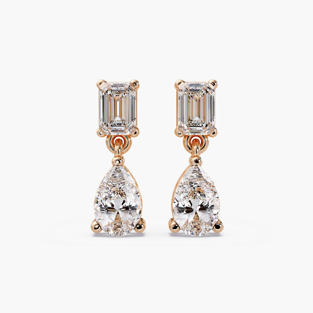 14K rose gold diamond dangle earrings with emerald cut top and pear shaped drop design