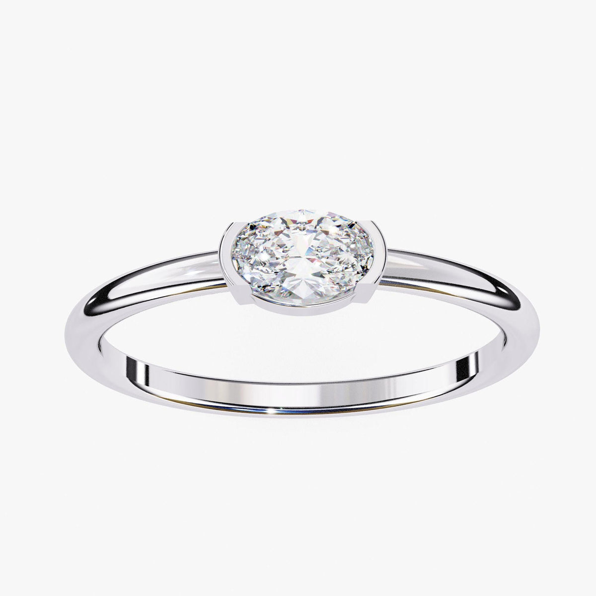 A silver ring with a large, round diamond set in the center.