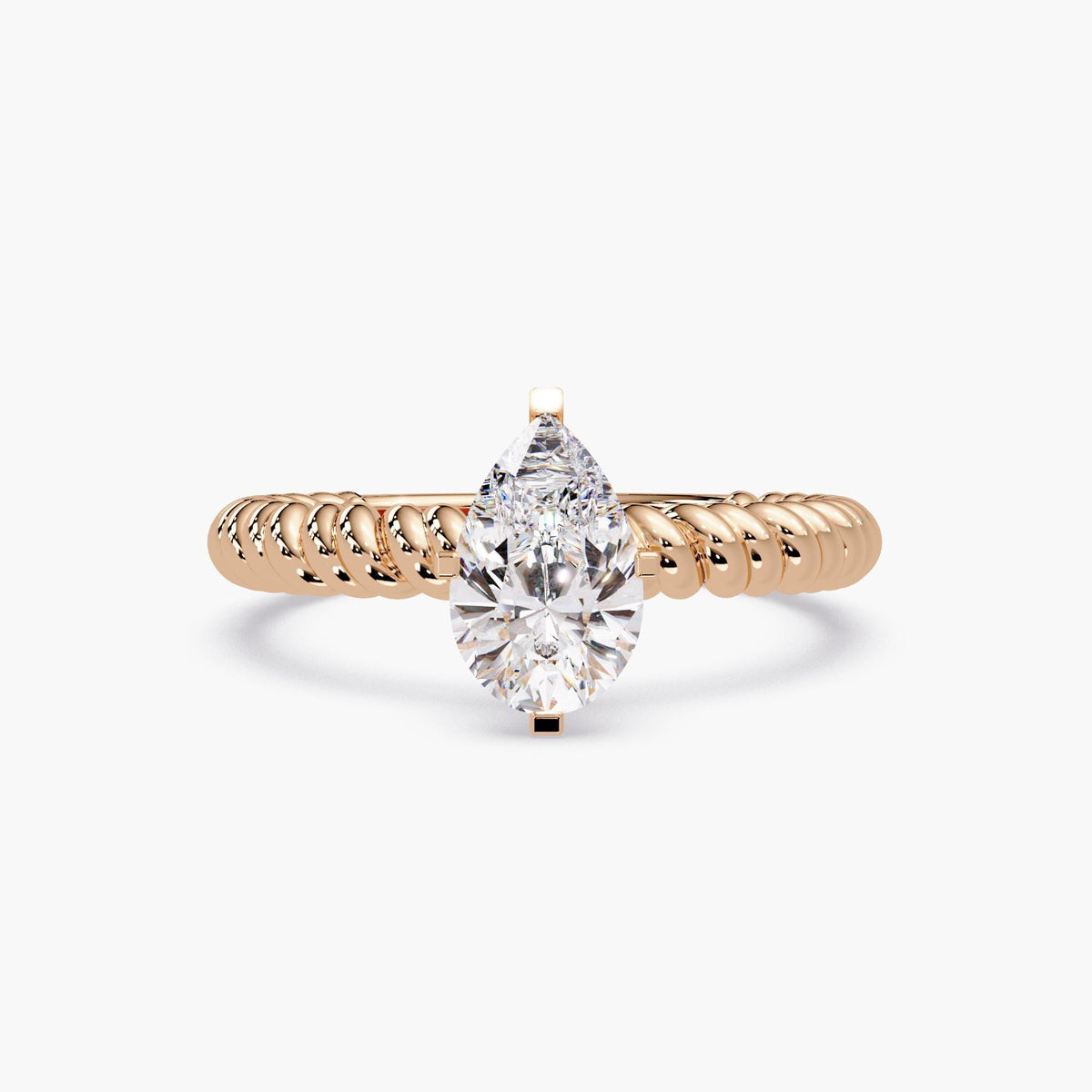 rose gold ring featuring a large pear-shaped diamond solitaire on a thick rope band.