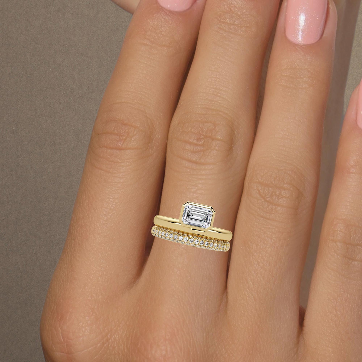 14k yellow gold emerald cut engagement ring on hand / offset diamond ring stack / bezel set lab diamond ring / bridal ring set for women / modern gold engagement ring