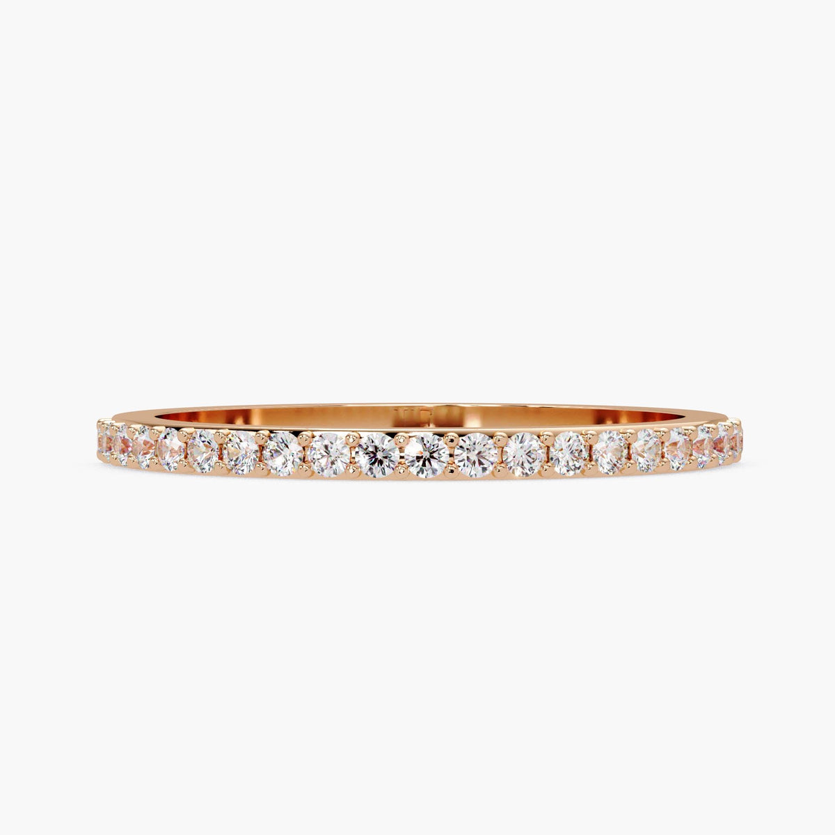 A gold band with a row of diamonds set in it.