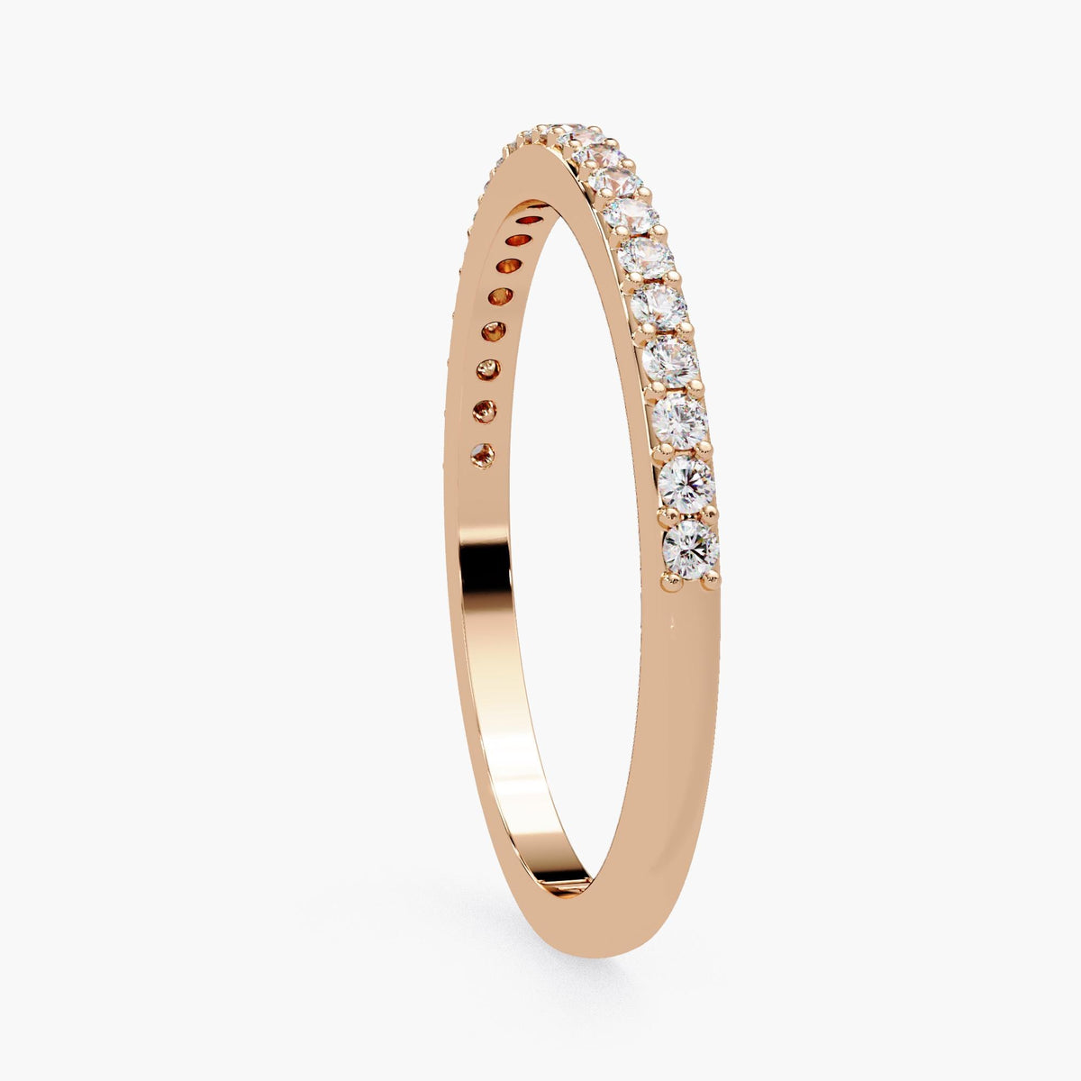 A gold ring with a row of diamonds along the band.