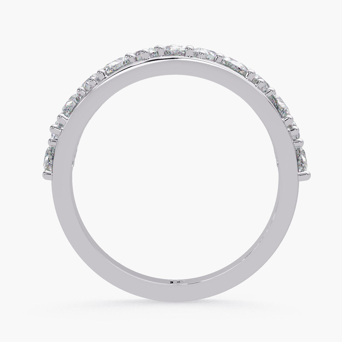 A silver ring with a row of diamonds along the band.