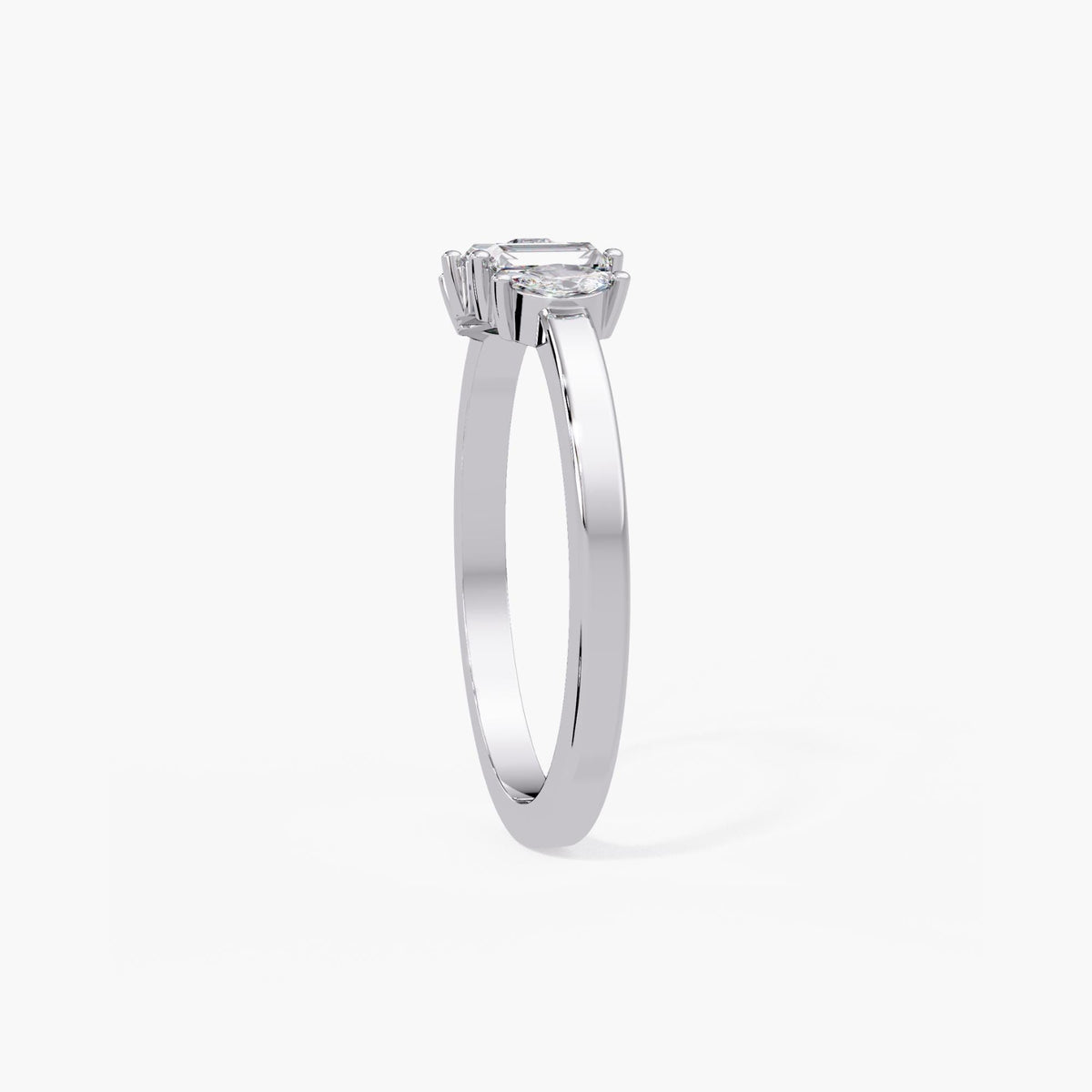A silver ring with a large central gemstone, possibly a diamond, surrounded by smaller gemstones.