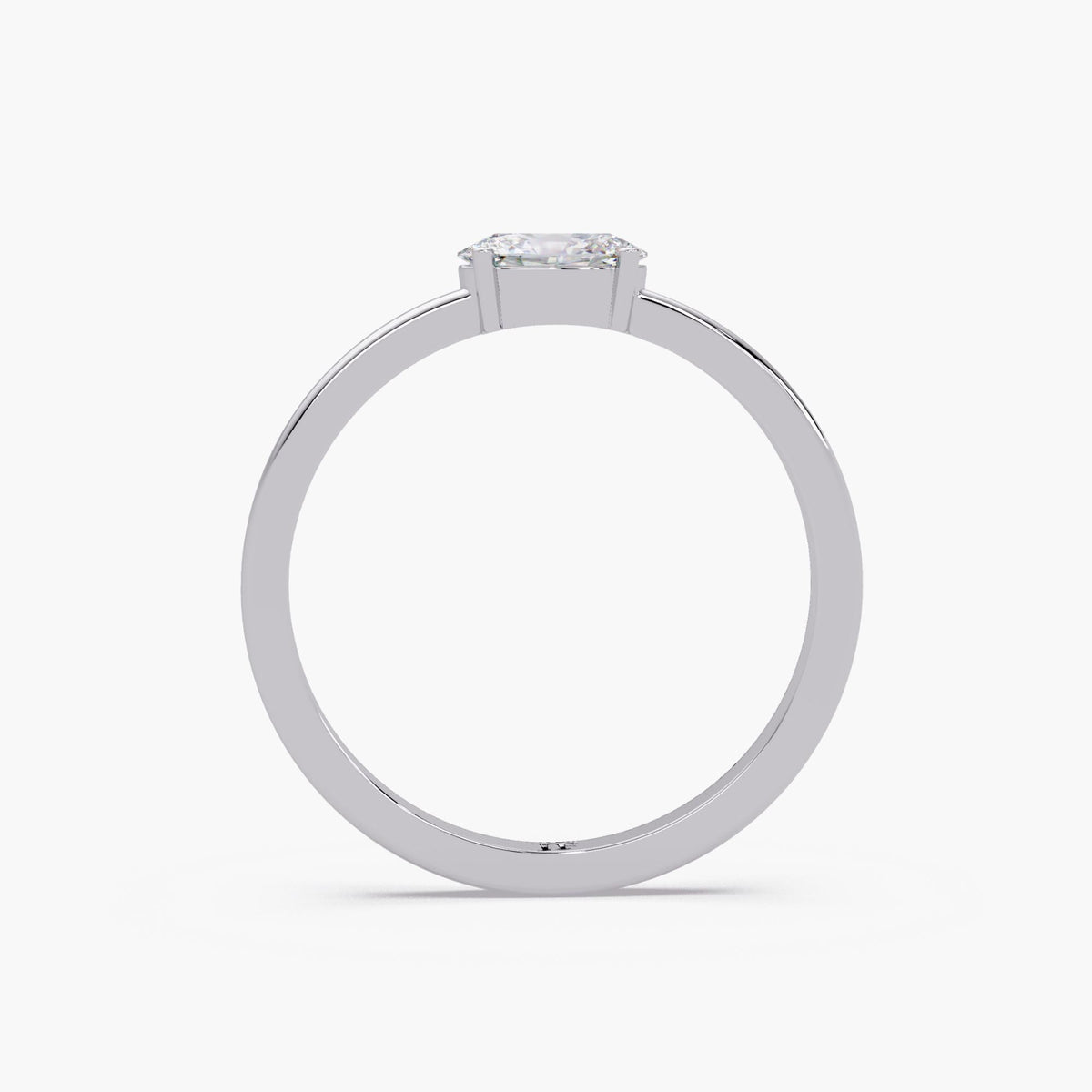 The oval solitaire ring shown from behind, revealing the open space beneath the center diamond and the polished 14K white gold shank.