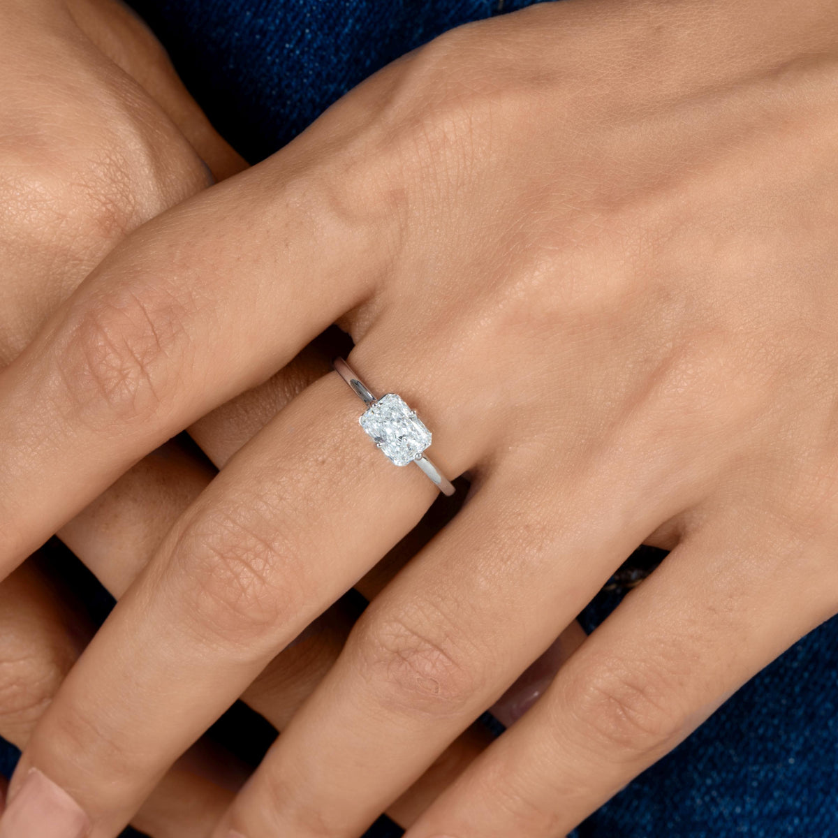 1 ct IGI-certified radiant-cut lab-grown diamond solitaire ring in 14K white gold with an east-west prong setting.