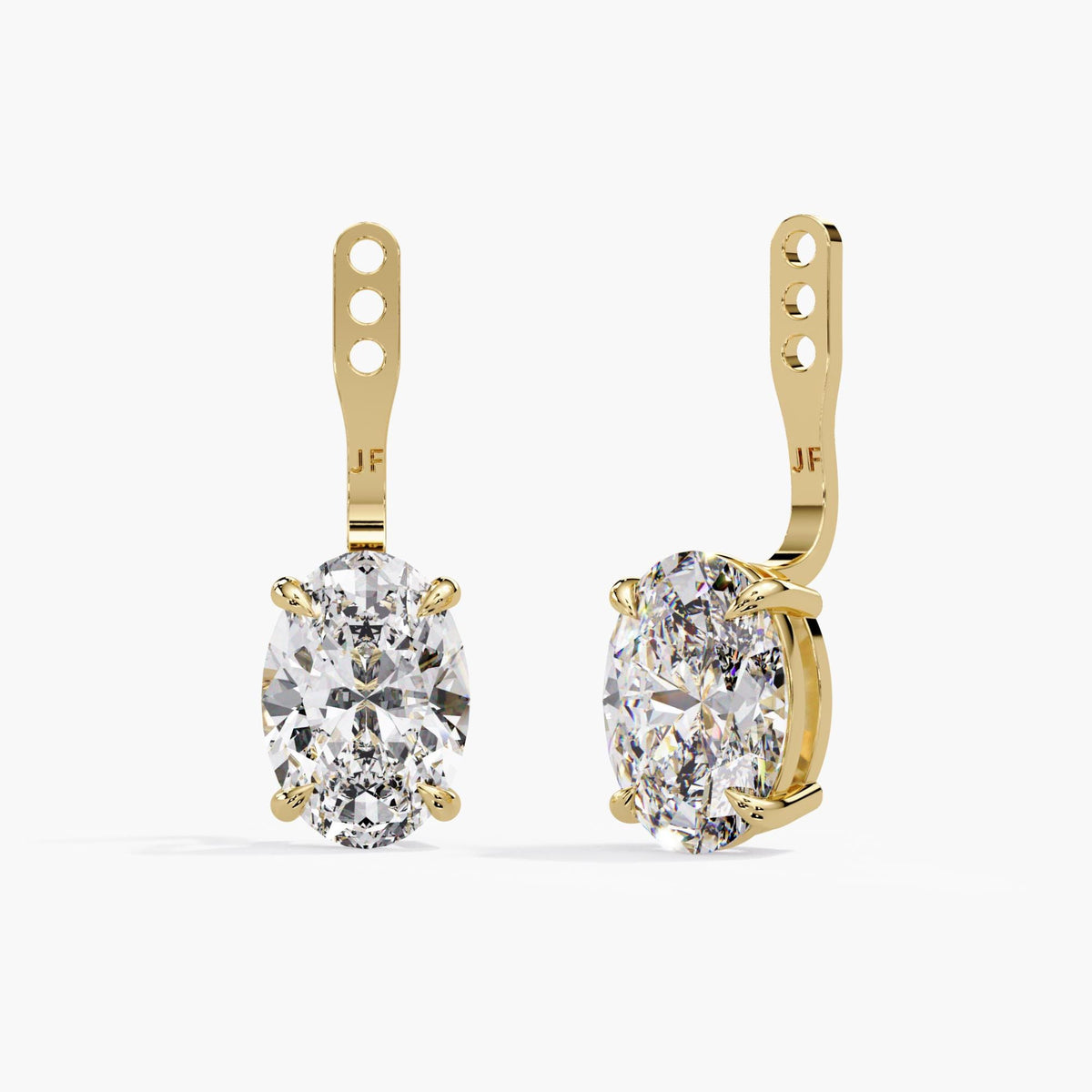 Adjustable oval lab-grown diamond earring jackets in 14K yellow gold with three placement holes and claw-set diamond drops for pairing with stud earrings.