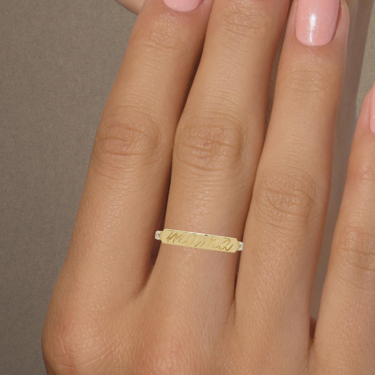 14k gold mama ring worn on the hand, featuring elegant script engraving and lab-grown diamonds, a personalized Mother’s Day or new-mom gift.