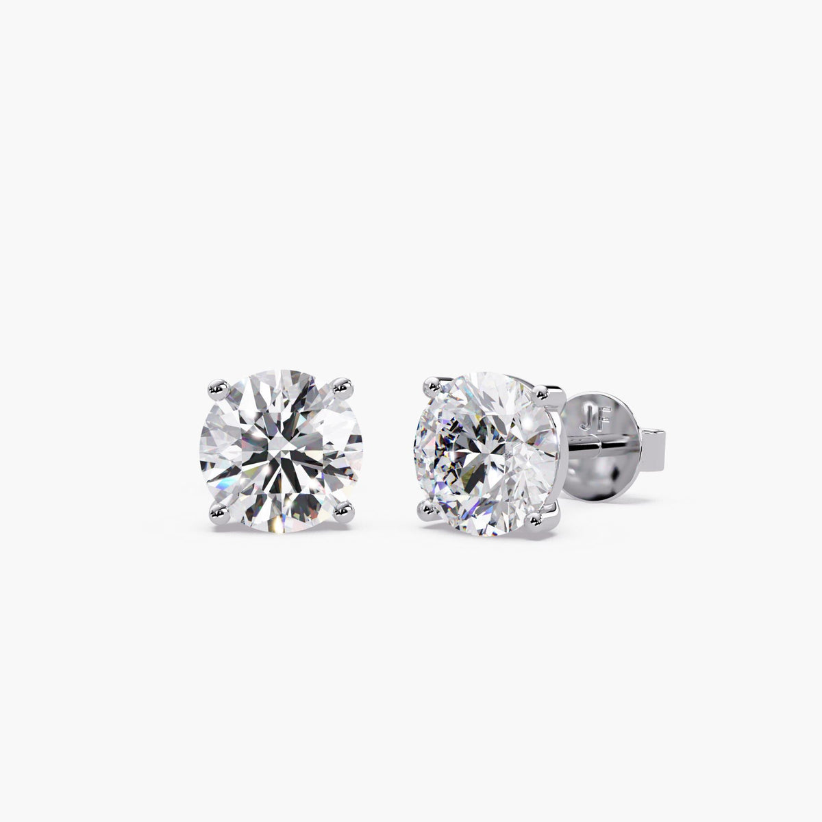 Round lab-grown diamond stud earrings in 14K white gold with four-prong settings and secure push-back closures.