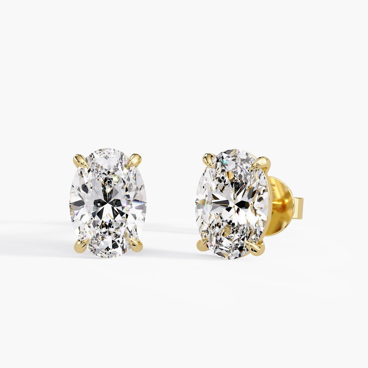 Oval lab-grown diamond stud earrings in 14K yellow gold with four-claw settings and pushback closures, available in 1CTW, 2CTW, 3CTW and 4CTW.