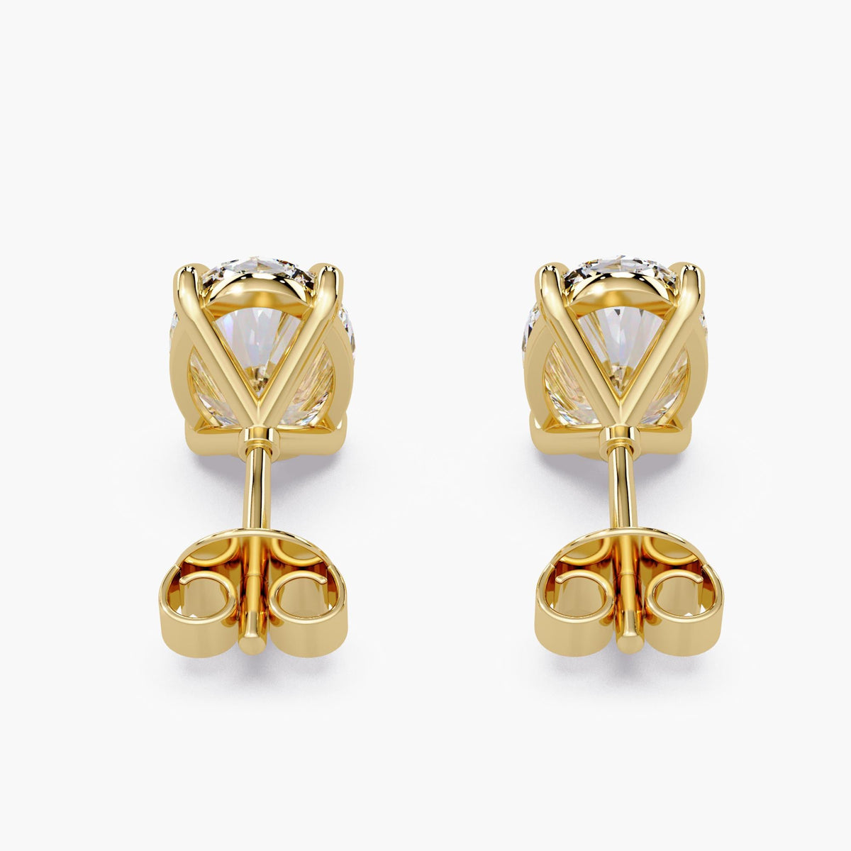 IGI-certified oval lab-grown diamond stud earrings in 14K yellow gold with sculpted four-claw baskets and butterfly pushback closures.