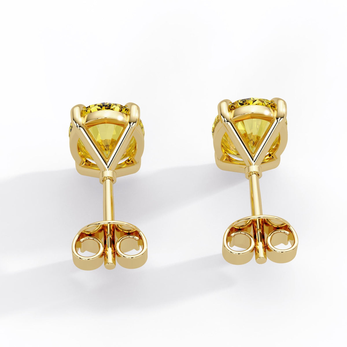 Oval fancy intense yellow lab grown diamond stud earrings in 14K yellow gold with open baskets, straight posts and butterfly pushbacks.