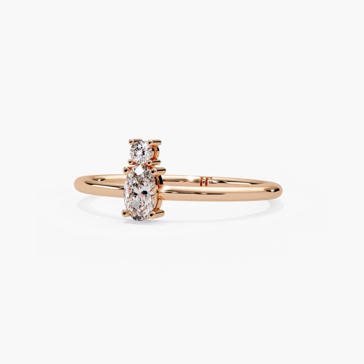 Dainty 14k rose gold oval and round diamond stacking ring, prong set and minimal enough to layer.