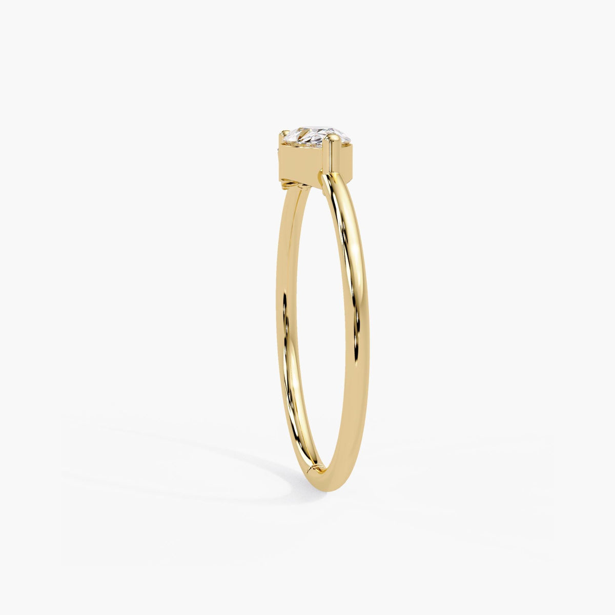 East west pear engagement ring in 14k gold with a slim 1.35mm band and a low set teardrop diamond.