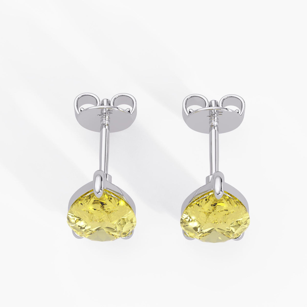 Yellow lab grown pear cut diamond stud earrings in white gold with push back closure