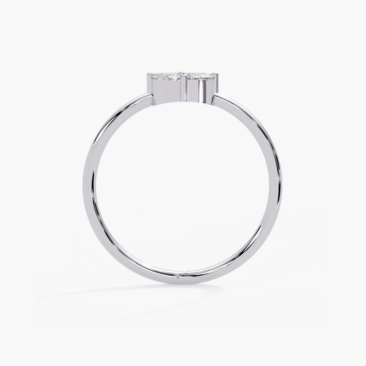 White gold diamond cluster ring with a slender circular shank and a raised prong setting supporting the floral design.