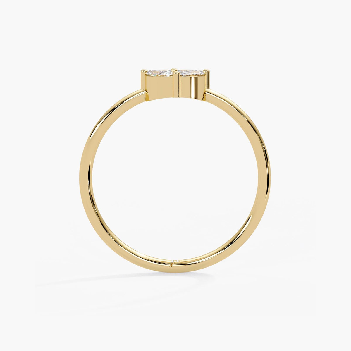 Yellow gold five-stone diamond ring with a polished circular band supporting a princess and marquise cluster.
