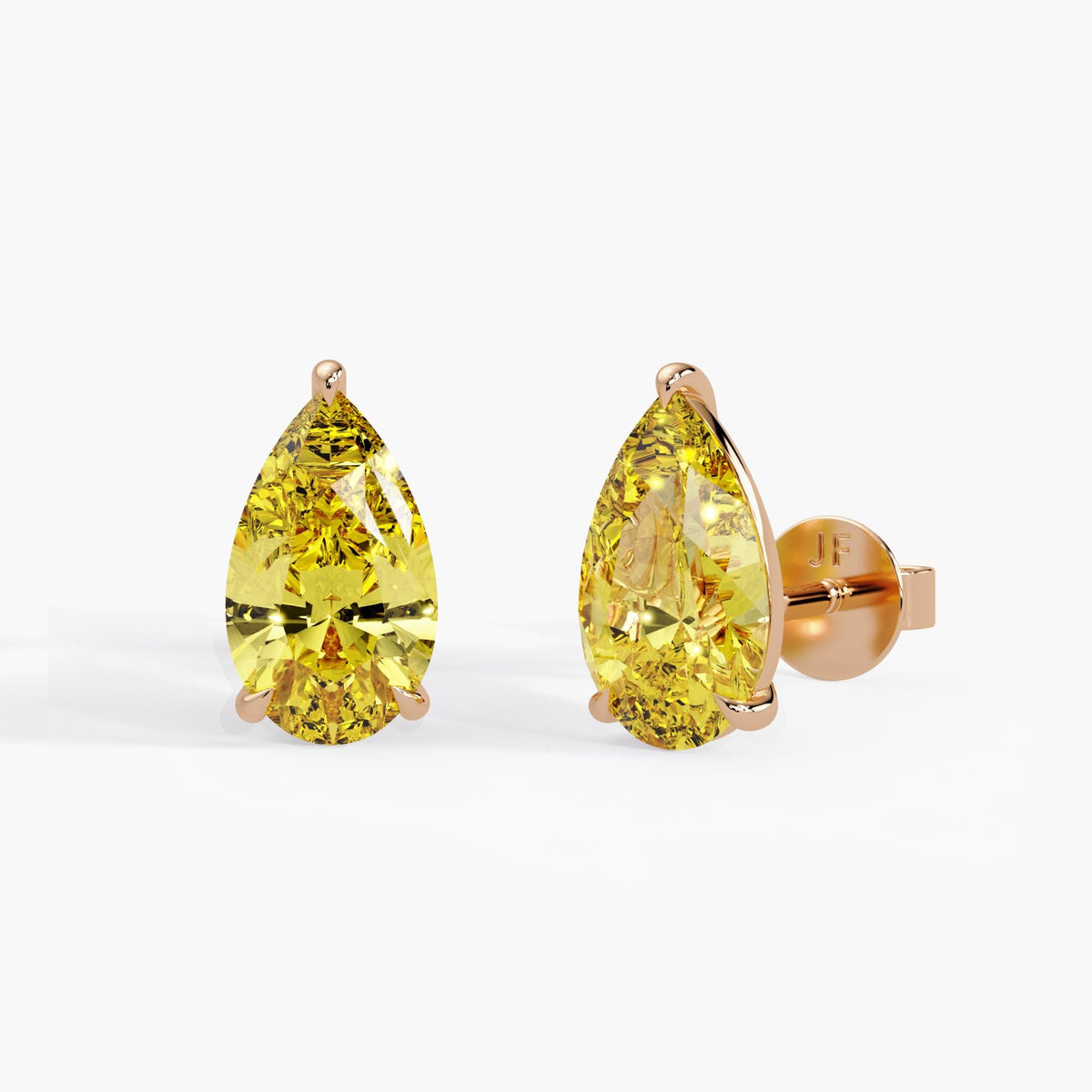Fancy yellow pear cut lab grown diamond stud earrings in 14K rose gold