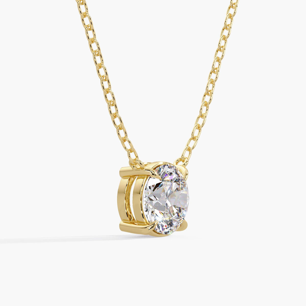 round lab-grown diamond solitaire necklace in 14K yellow gold, showing the open basket, four-prong setting and cable chain.