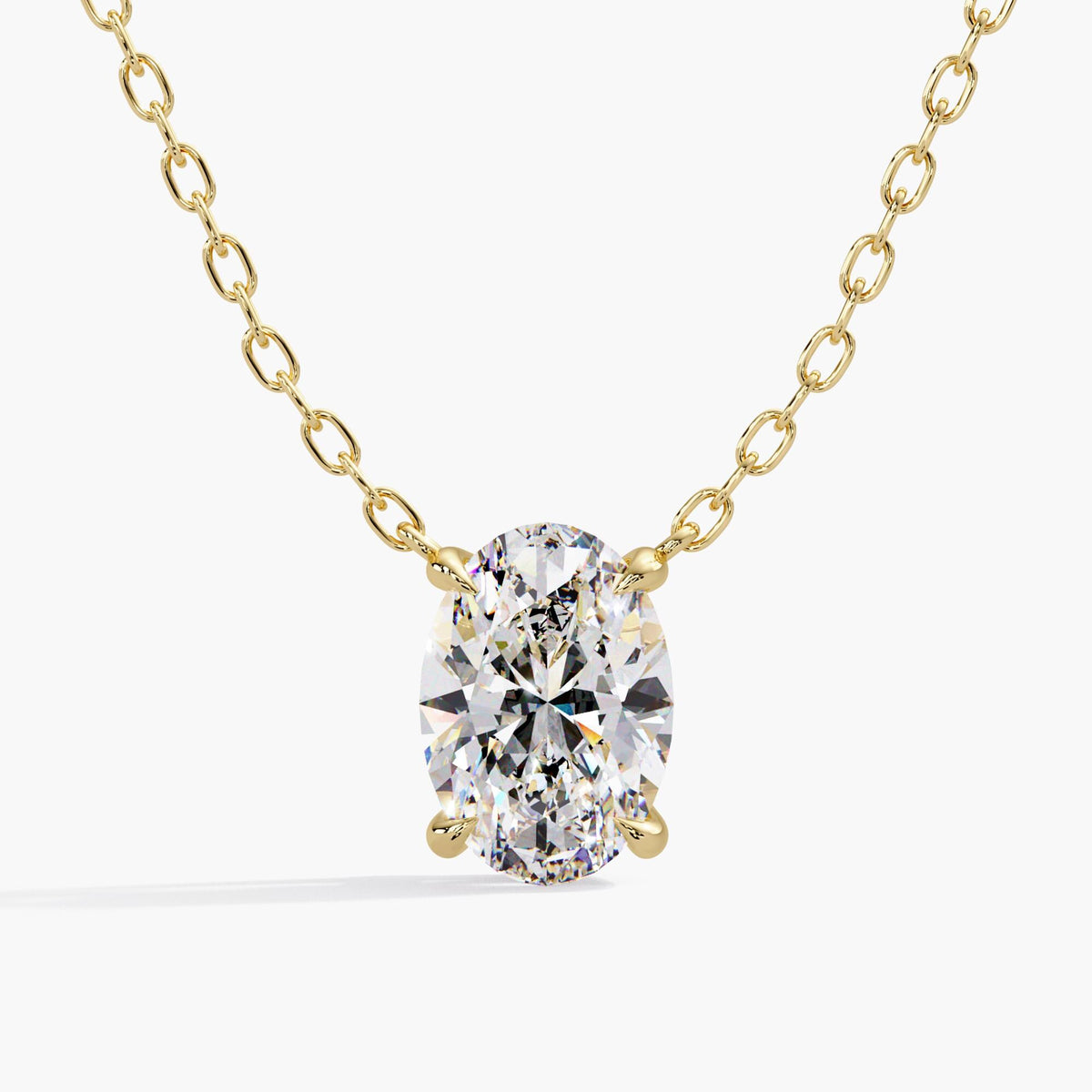 Oval lab-grown diamond pendant necklace in 14K yellow gold, featuring a four-prong solitaire setting and cable chain