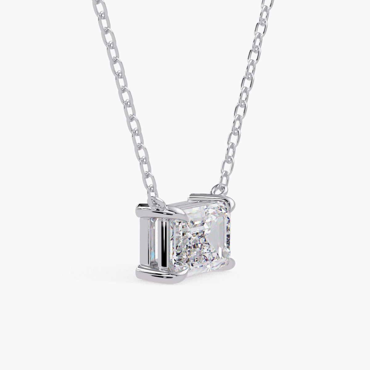 diamond solitaire necklace / emerald cut lab created diamond / white gold fine jewelry / four-prong pendant / angled close-up