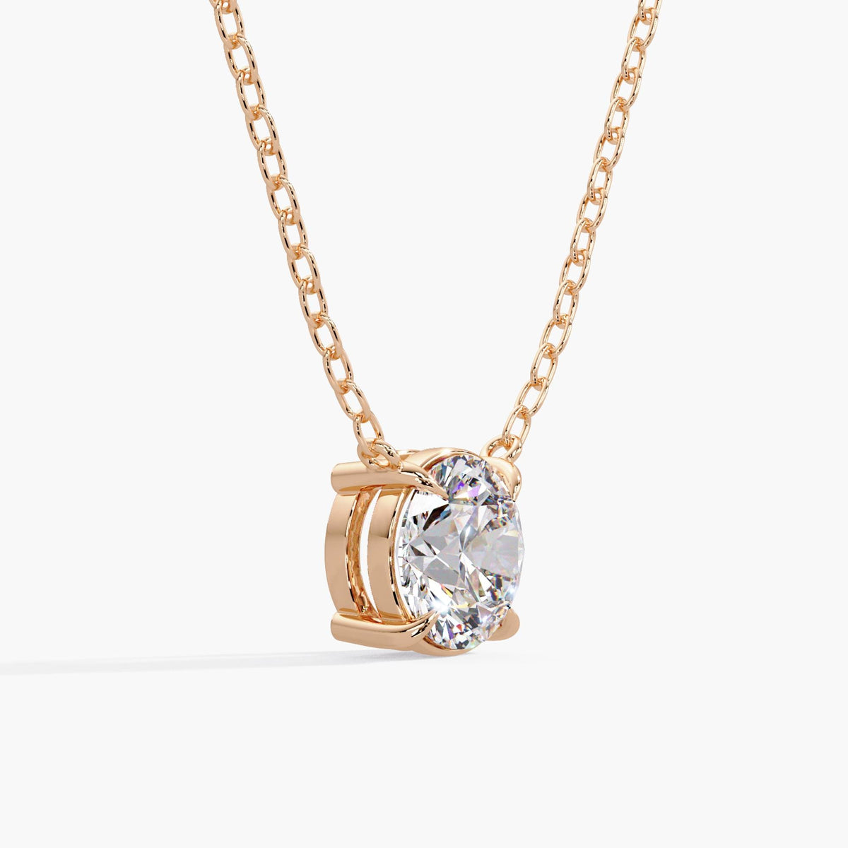 minimalist diamond necklace in 14K solid rose gold, showing a round brilliant lab-created diamond, open basket setting and diamond cut cable chain.