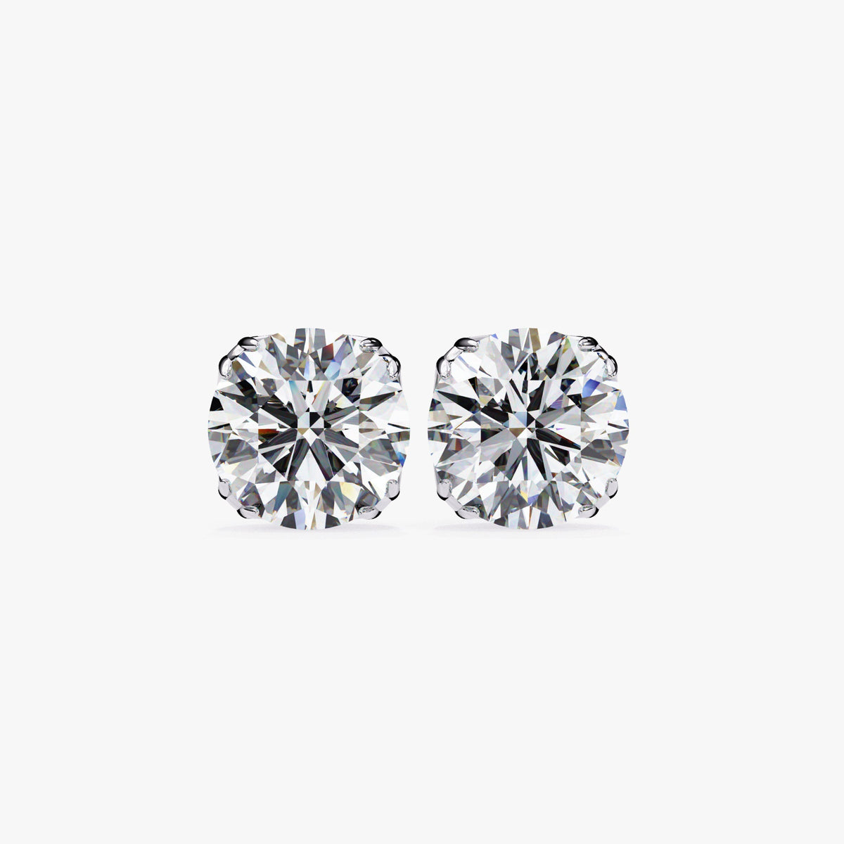 A pair of round diamond stud earrings shown in white gold with brilliant-cut diamonds and secure prong settings.