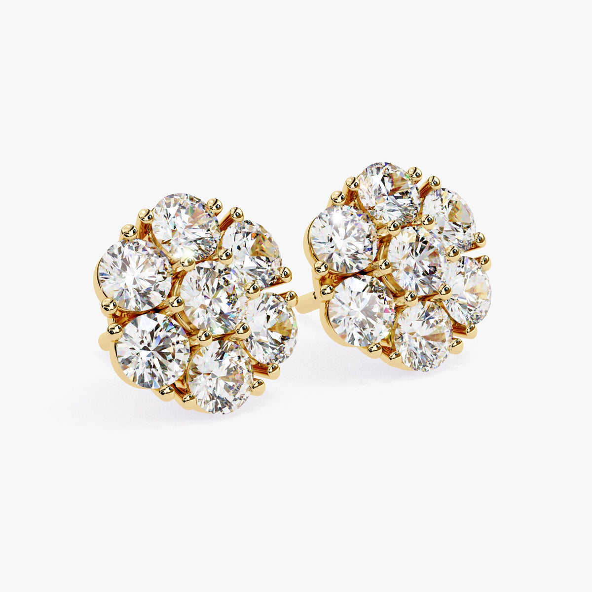 A pair of 14k yellow gold flower-shaped stud earrings with round lab-grown diamonds arranged in a cluster setting.