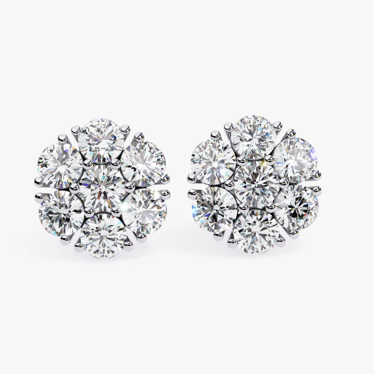 A pair of 14k white gold floral cluster earrings with round lab-grown diamonds arranged in a flower shape.