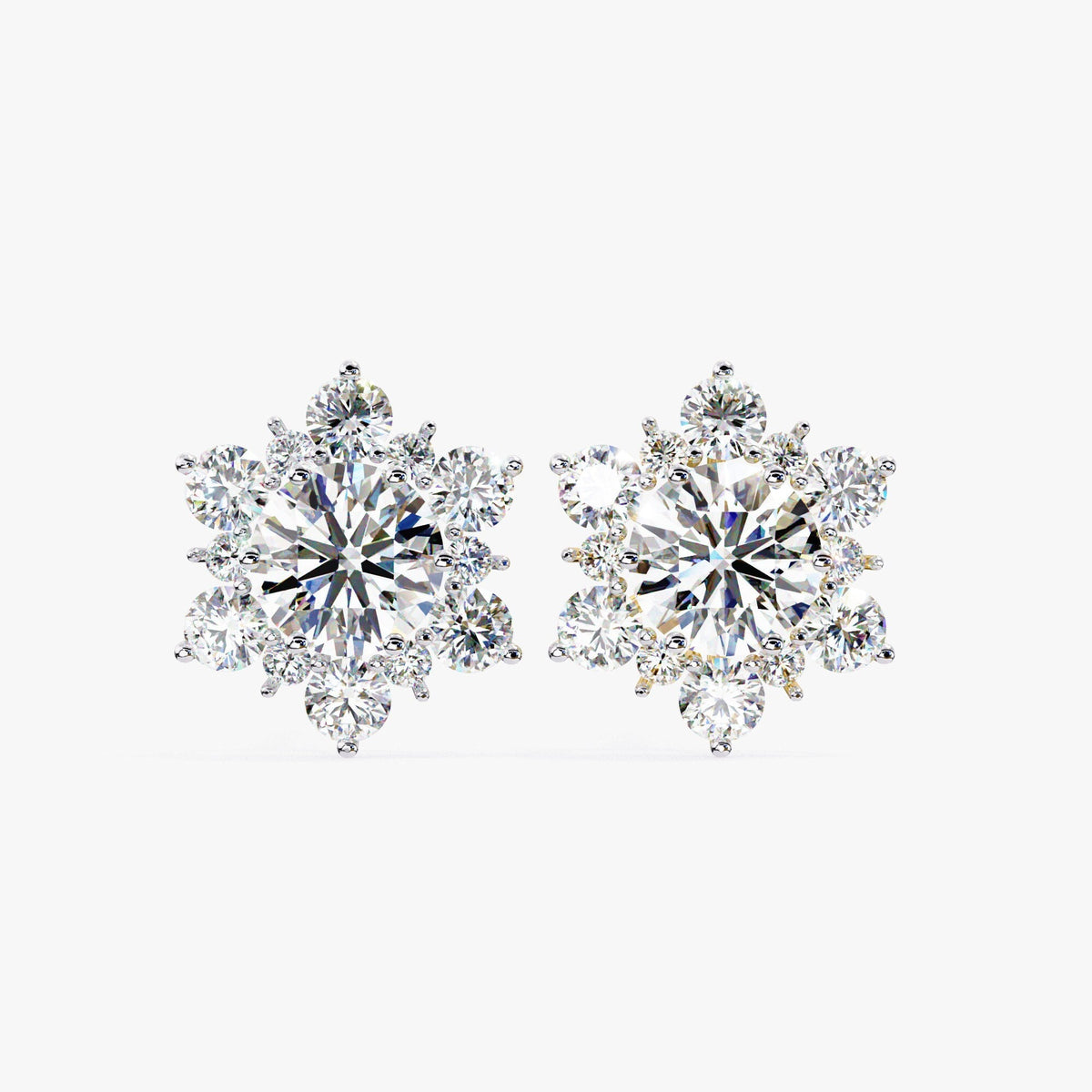 Two snowflake-shaped diamond stud earrings with round lab-grown diamonds set in a floral cluster design, shown in white gold.