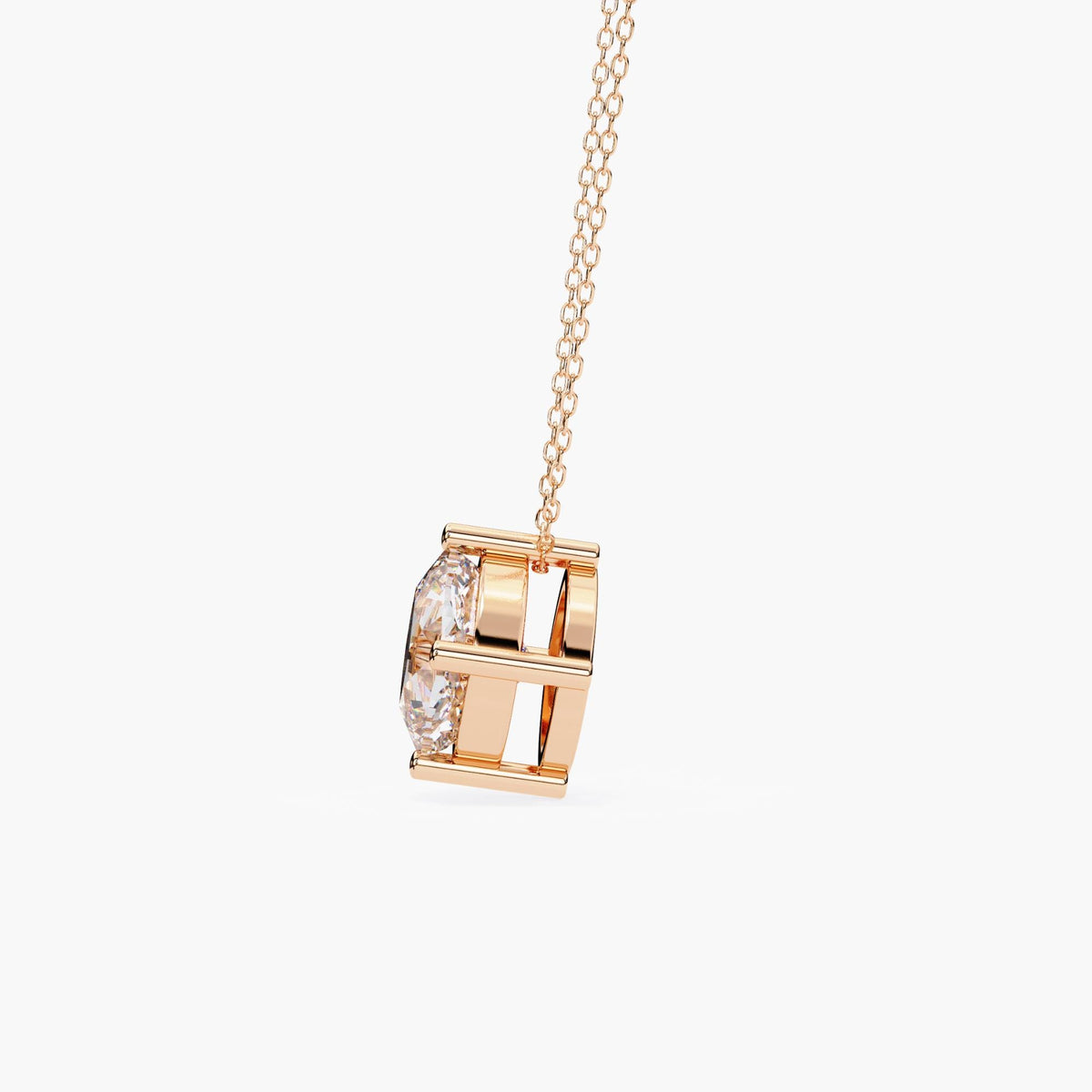 Side view of a cushion cut lab-grown diamond pendant in 14k rose gold, showing the open gallery setting and secure chain threading through the top.