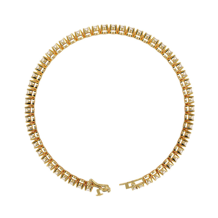 A gold bracelet with a row of small clear diamonds.