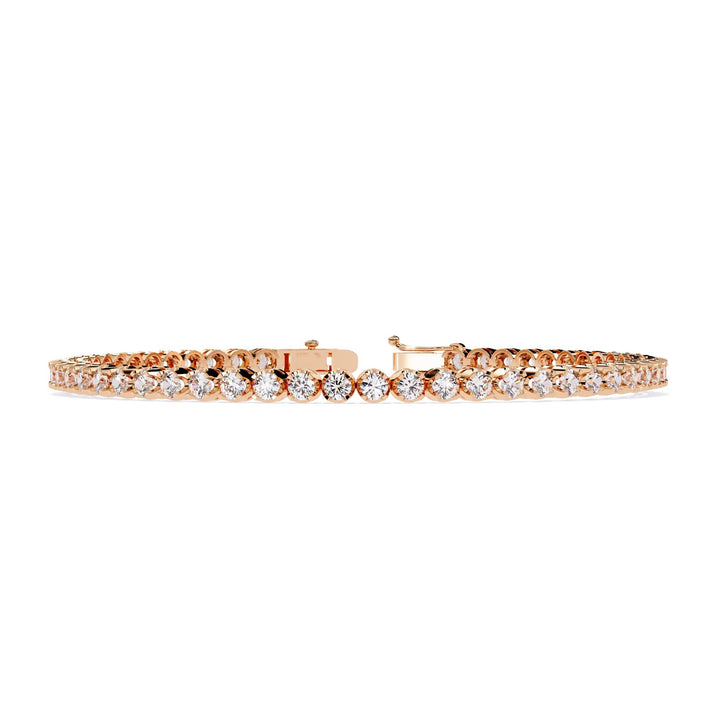 A rose gold bracelet with a row of small clear diamonds.