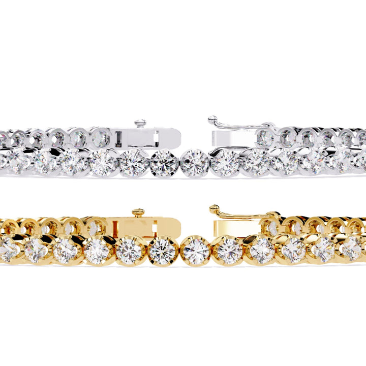 A gold and white gold bracelet with a row of small clear diamonds.