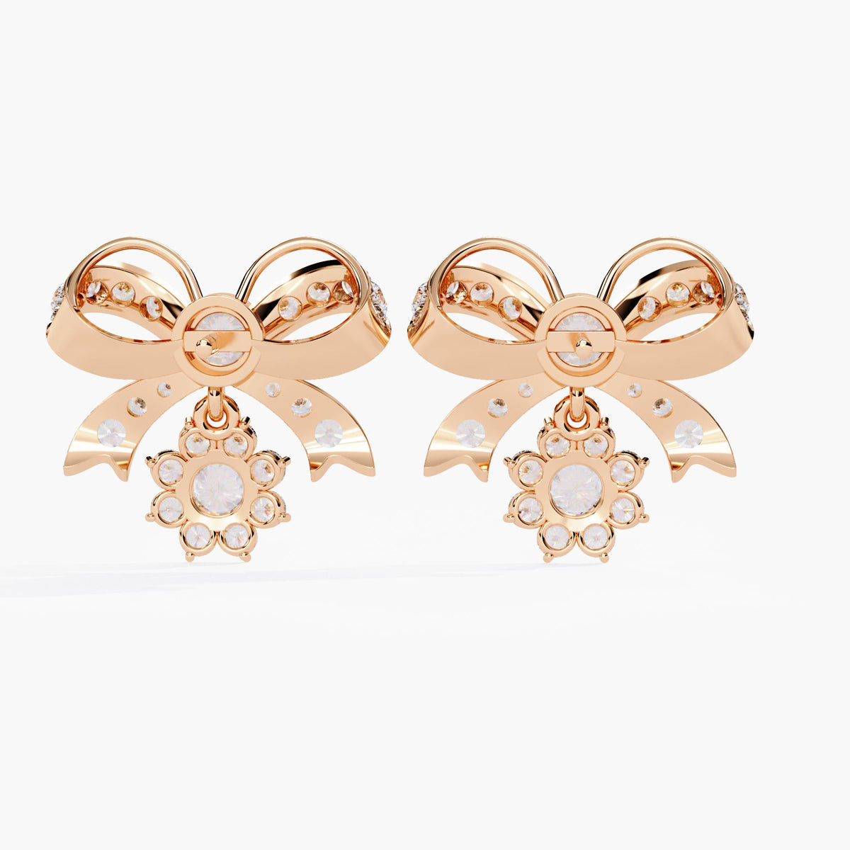 A pair of rose gold bow earrings with dangling clear round diamonds. The bows are made of small clear stones with rose gold accents.