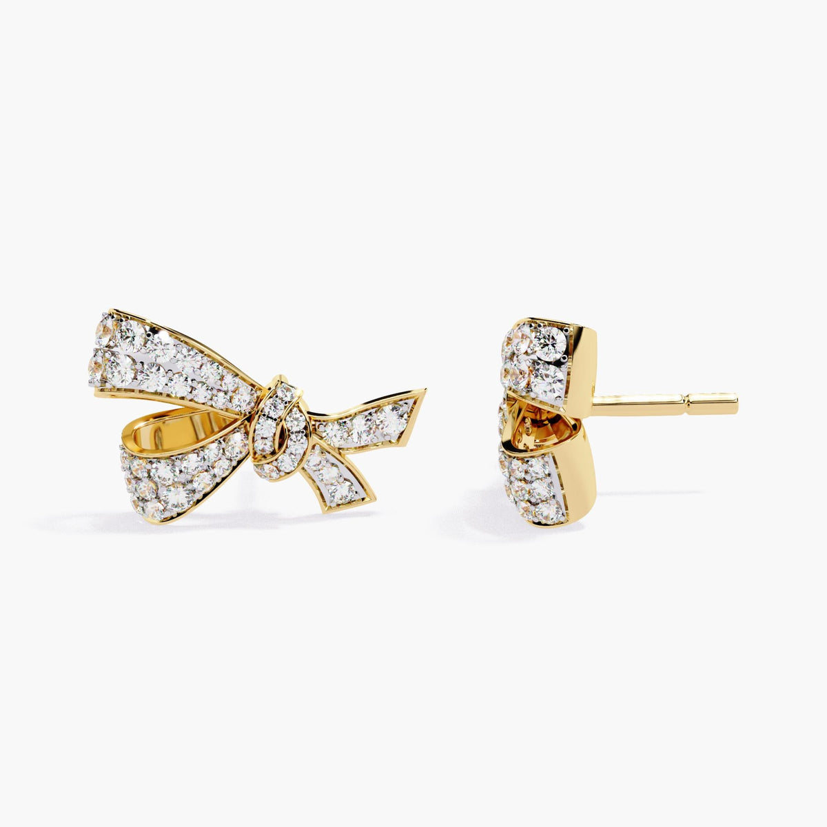 A pair of gold earrings with a small bow design made of clear diamonds.