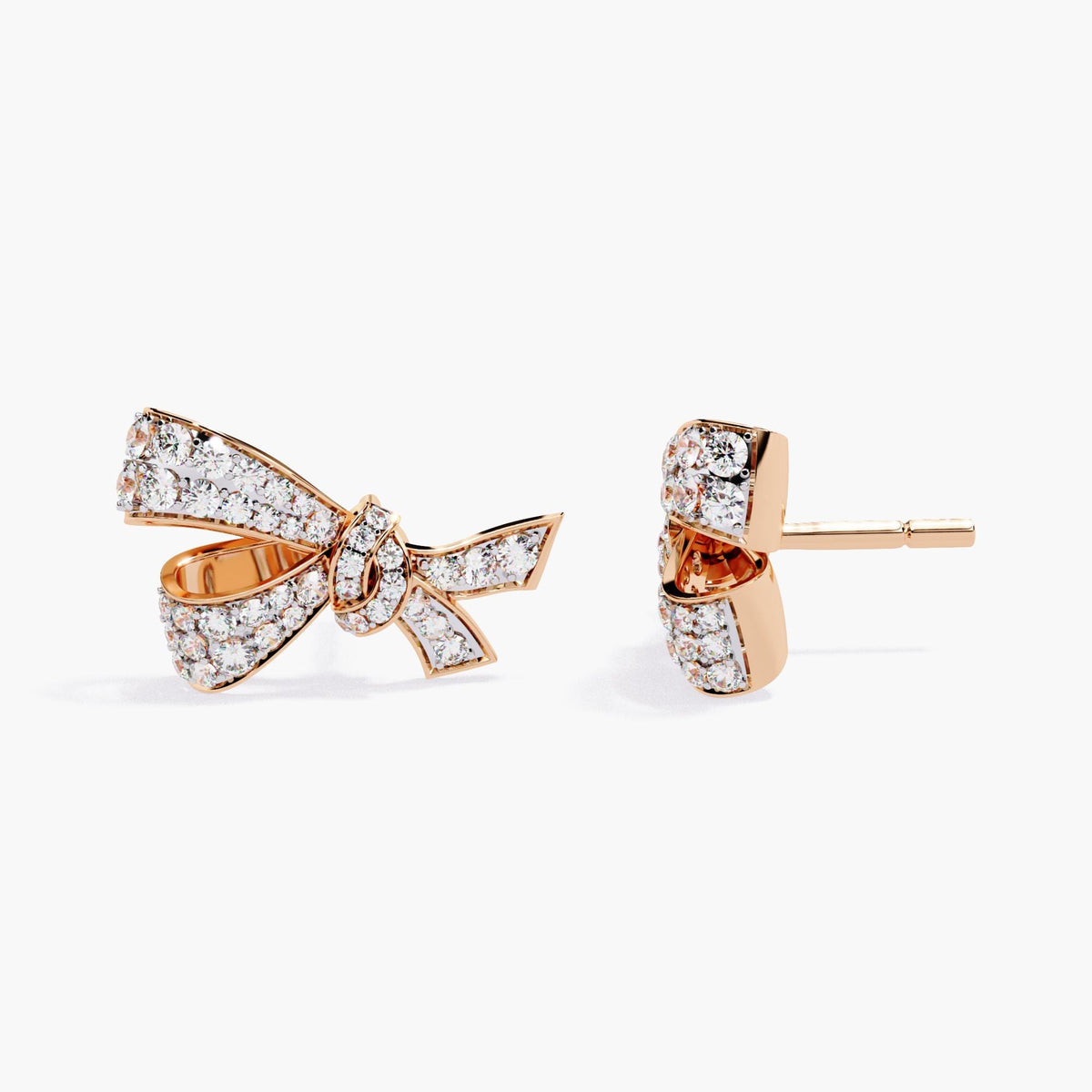 A pair of rose gold earrings with a small bow design made of clear diamonds.