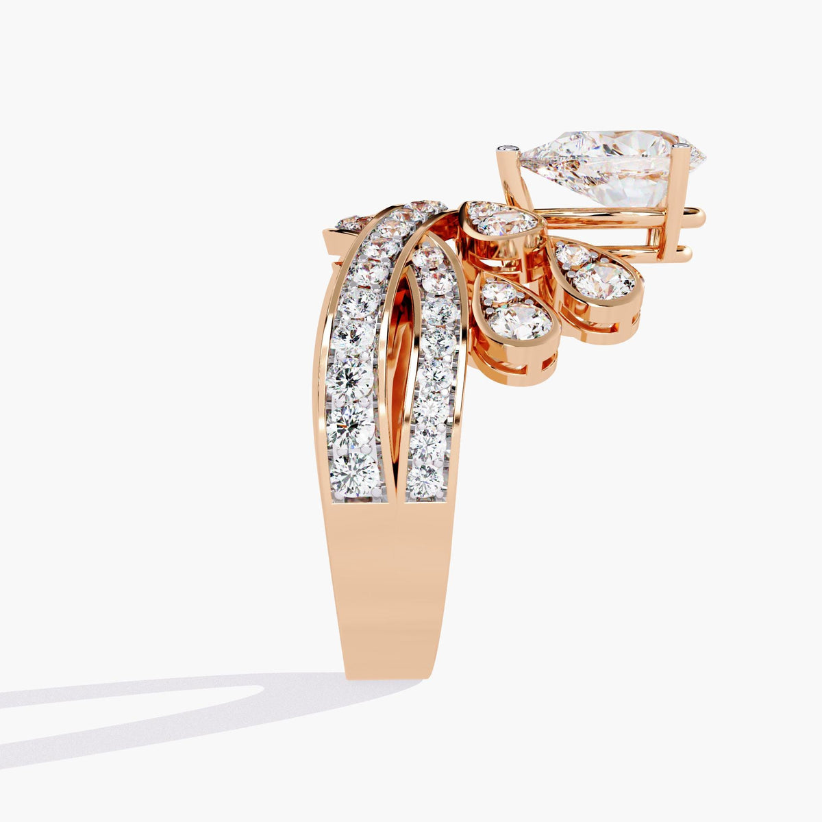 A rose gold ring with a pear-shaped diamond center stone and smaller diamonds set in a crown-like design.