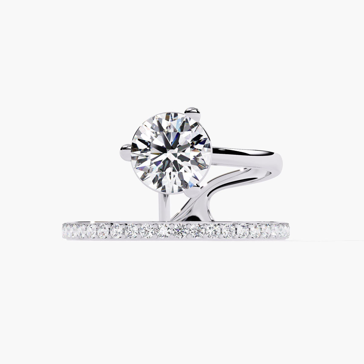 A white gold engagement ring with a round brilliant cut diamond center stone and a pave diamond band. The band is split and wraps around the center stone.