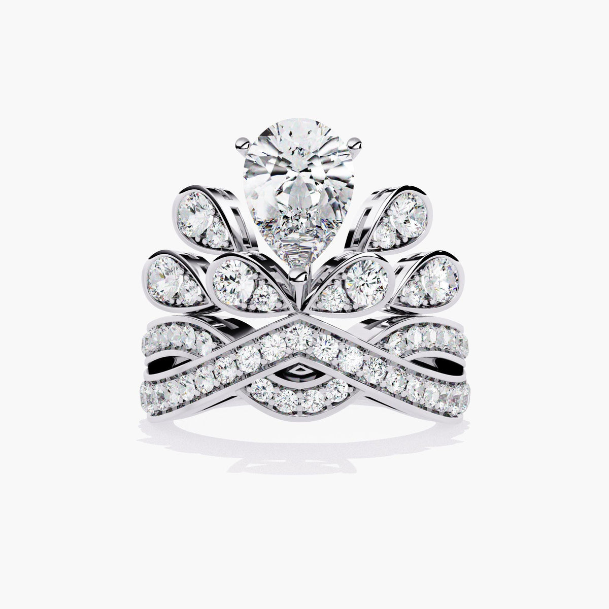 A white gold ring with a pear-shaped diamond center stone and smaller diamonds set in a crown-like design.