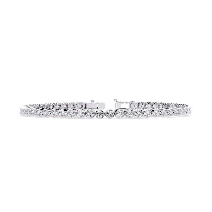 A white gold bracelet with a row of small clear diamonds.