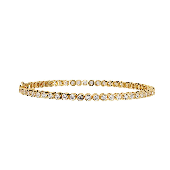 A gold bracelet with a row of small clear diamonds.