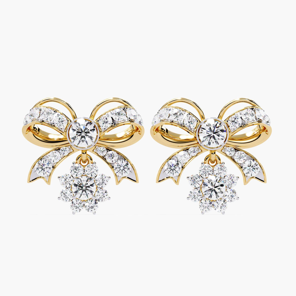 A pair of gold bow earrings with dangling clear round diamonds. The bows are made of small clear stones with gold accents.
