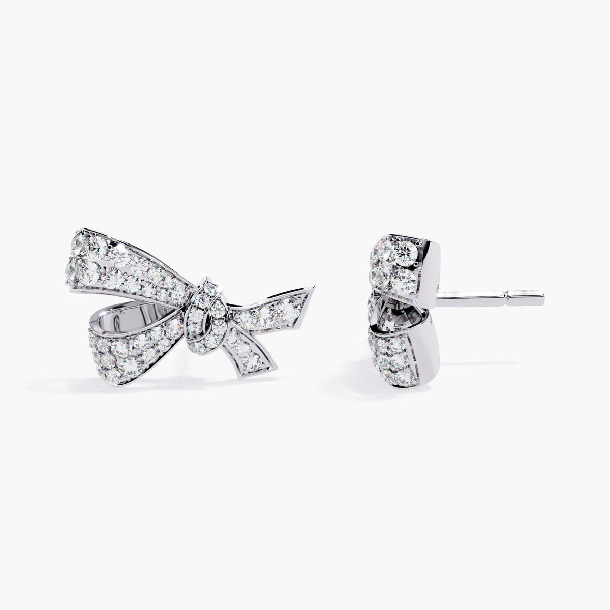 A pair of white gold earrings with a small bow design made of clear diamonds.